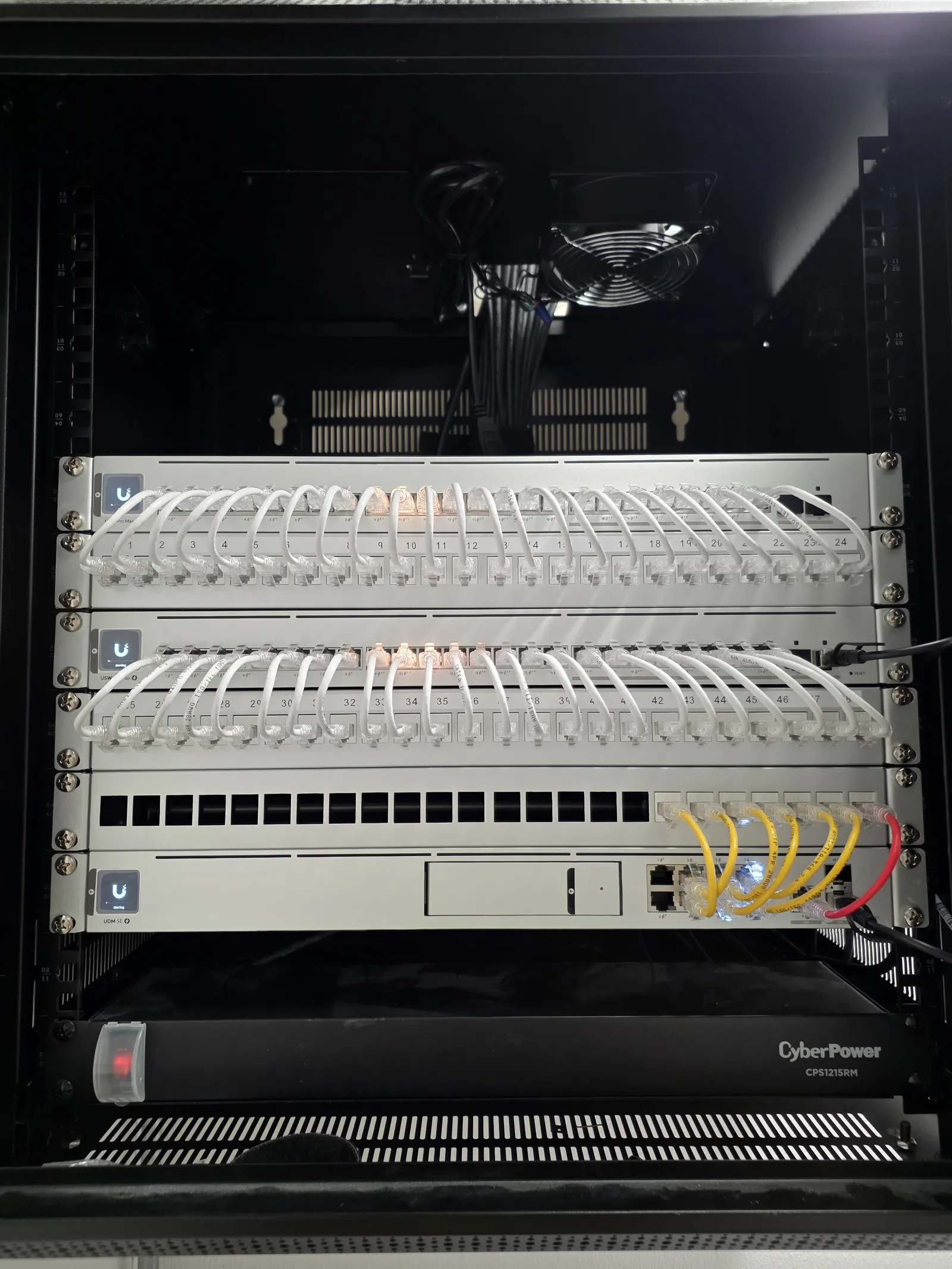 Wall-mounted network rack with patch panel, fiber, and UPS installed by INTEK at an Iowa clinic