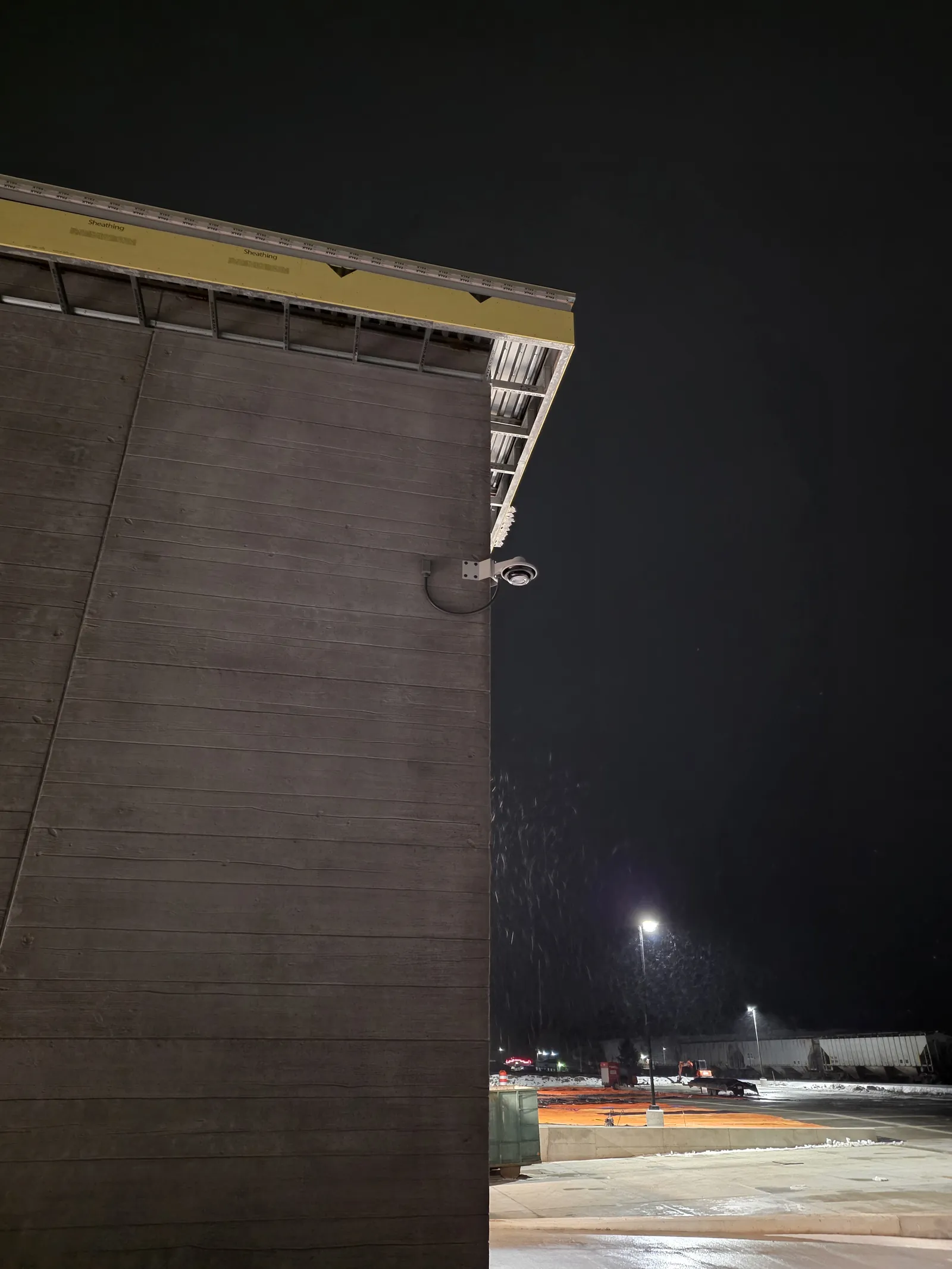 INTEK-installed exterior camera overlooking a lit parking lot at night